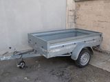 an image of a small trailer parked in front of a building