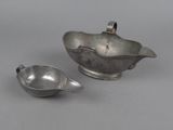 two pieces of silverware sitting on top of a table