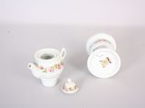 a small cup and saucer sitting next to each other