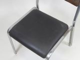 a black chair with a wooden seat on a white surface
