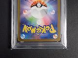 a close up of a pokemon trading card in a plastic case
