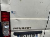 a small white van with a sticker on the back of it