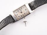 a watch that is laying on a white surface