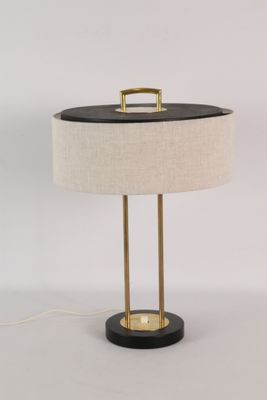 une lampe de table noire et dorée avec un abat-jour blanc