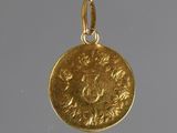 a close up of a gold coin with a bird on it