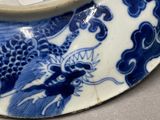 a blue and white plate with a dragon on it