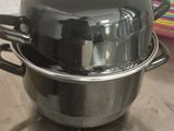 pots and pans are sitting on a table in a kitchen
