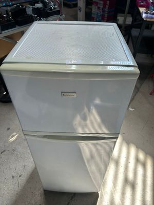 un réfrigérateur blanc placé dans une pièce