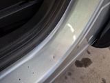 a close up of a car ' s door handle with a hole in it