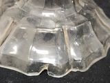 an image of a clear glass candle holder on a black surface