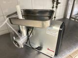 a meat grinder sitting on a counter in a kitchen