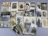 several old black and white photographs of men and women on a table