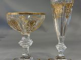 two glass goblets sitting next to each other on a table