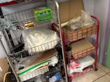 a metal cart with many items on it in a room