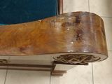 a wooden bench that has a blue cushion on top of it
