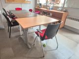 a table with chairs and a ball on it in a room