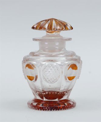 a glass jar with a lid that has an orange design on it