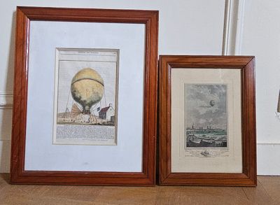 two framed pictures of a hot air balloon on the floor