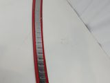 a close up of a red and white car tail light on a white surface