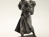 statue of a woman holding a basket of flowers on a marble base