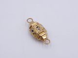 an image of a gold charm with a clock on it