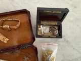 a wooden box with a bunch of jewelry inside of it