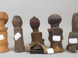 several wooden sculptures of different shapes and sizes on a white surface