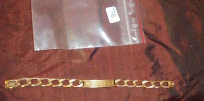 un bracelet en or et un bracelet en or posé sur un tissu marron