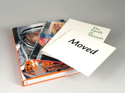 a stack of books with a picture of a man in a space suit on top of them