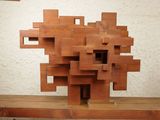 a sculpture made out of wood blocks on a wooden table