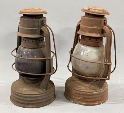 two old lanterns sitting next to each other on a table