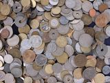 a lot of coins that are on a blue table