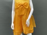 mannequin wearing a yellow dress with a bow on the front
