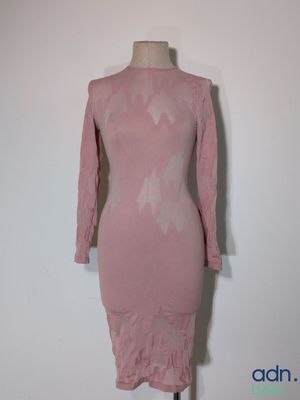 pink dress on a mannequin stand against a white wall