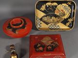 a red box with a black and gold design and a red and gold box with a black and gold design and a red and gold box with a gold