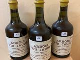 three bottles of wine sitting on top of a wooden box