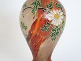 a vase with a floral design on it on a white background