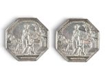 two silver coins with a picture of a man and a woman on them