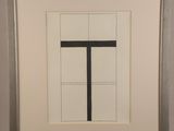 painting of a black and white cross in a frame on a wall