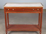 a wooden table with a marble top and two drawers