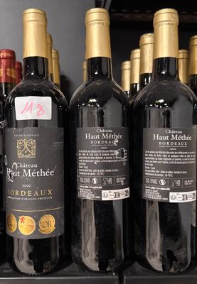 many bottles of wine sitting on a shelf in a store
