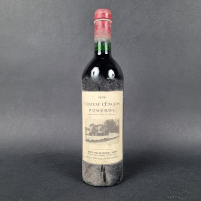 an old bottle of wine sitting on top of a table