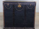 a black trunk sitting on the floor in a room