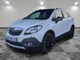 Une Opel blanche est garée dans une pièce au sol carrelé.