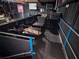 a room that has a lot of chairs and tables in it