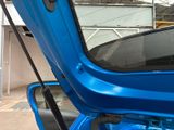 a close up of a blue car with the door open
