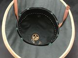 an image of a green hat with a brown leather strap