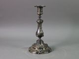 a silver candle holder on a table with a white background