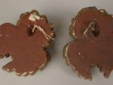 two pieces of clay that are shaped like animals