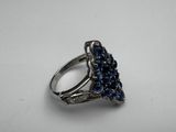 a close up of a silver ring with blue stones on it